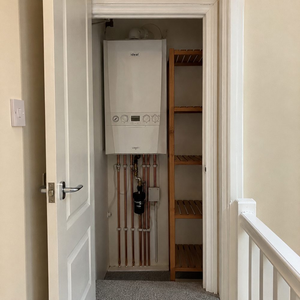 Combi boiler newly installed in an airing cupboard during a boiler swap in Earley
