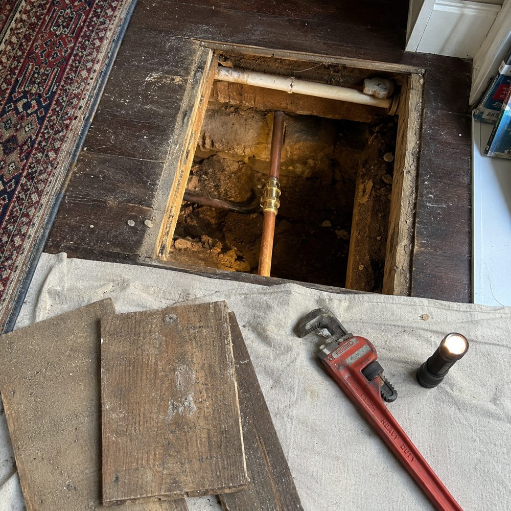 Repaired copper pipe with new fitting under lifted floorboards in Caversham